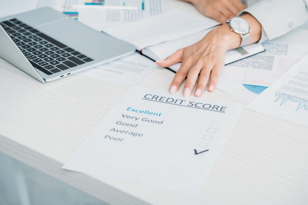 cropped view of woman showing bad credit score at office
